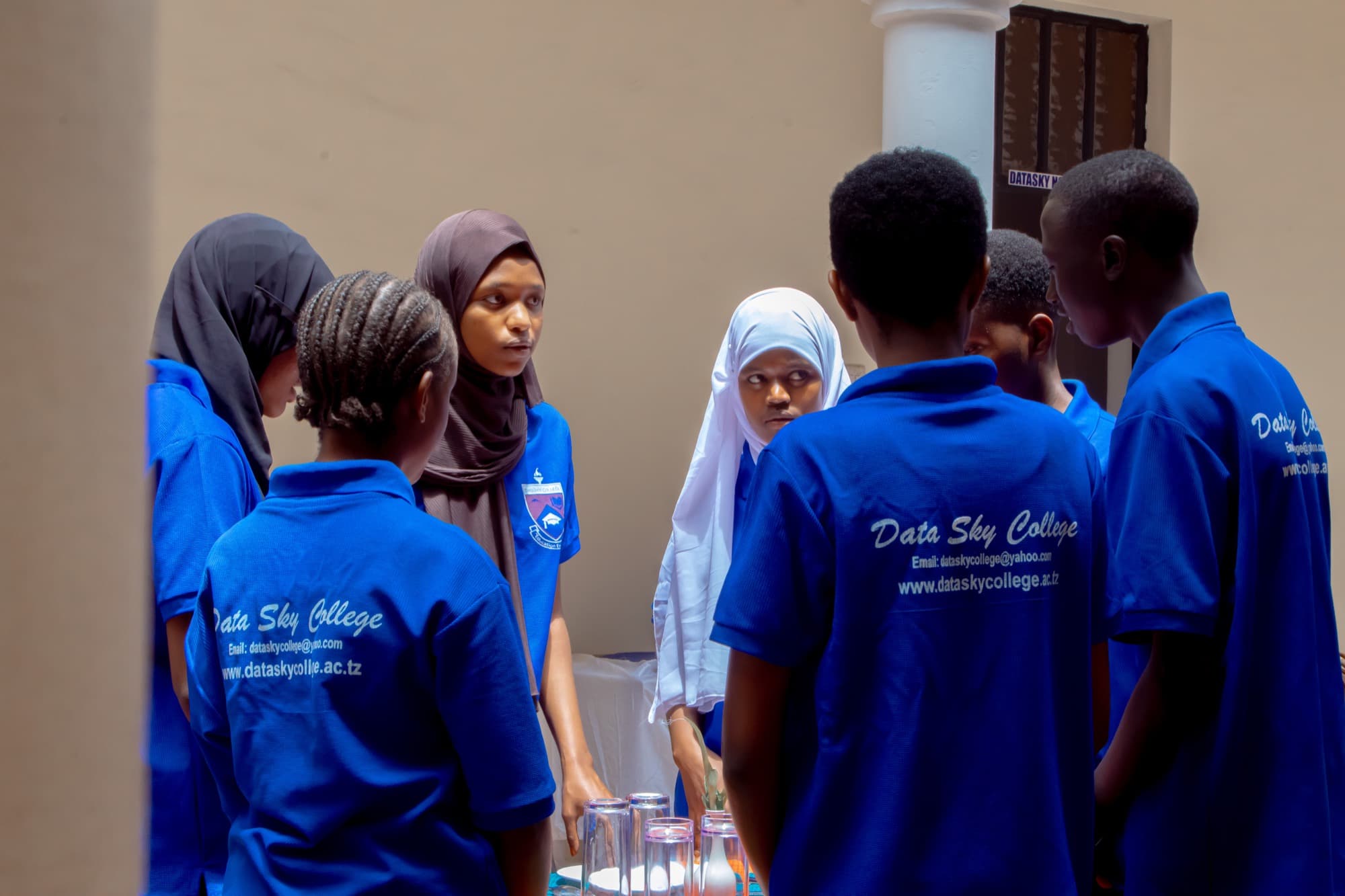 Datasky College students standing together at a service counter during a practical session