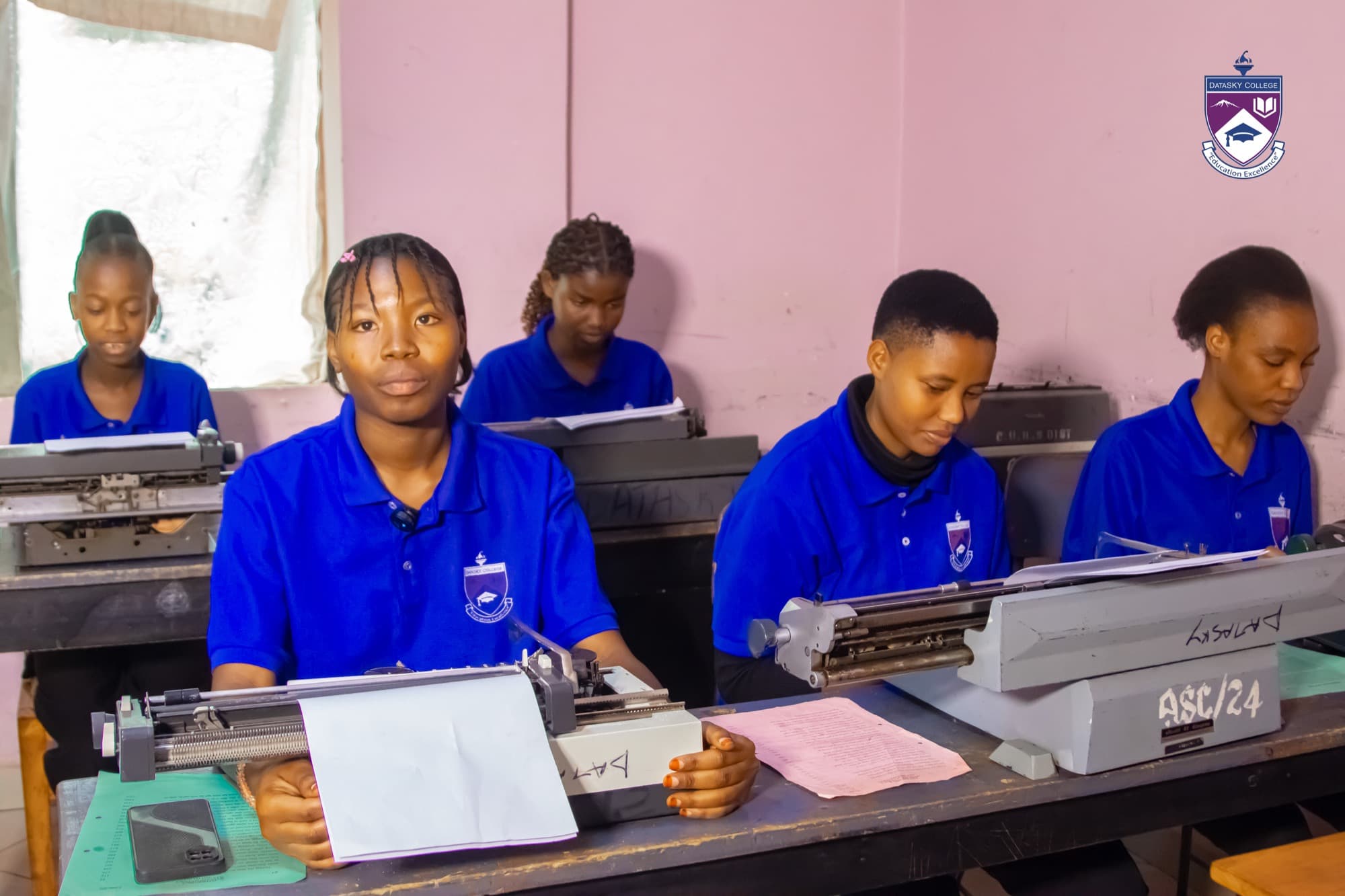 Datasky College students practising on manual typewriters in the typing classroom